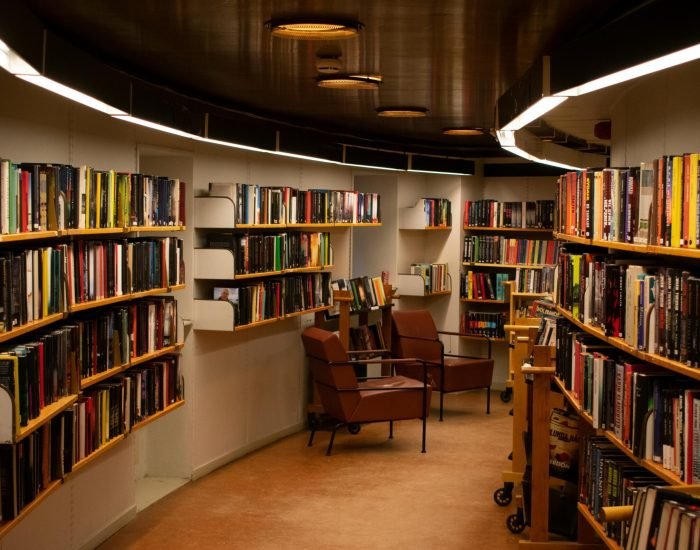 pexels photo 2041540 2041540 A cozy library space in Stockholm with brown leather chairs and wooden bookshelves filled with books.